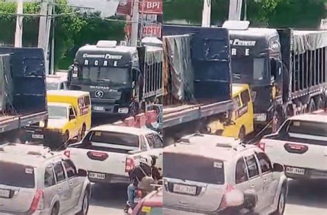 Vehicle crushed between 2 trucks in Lipa City; driver hurt .